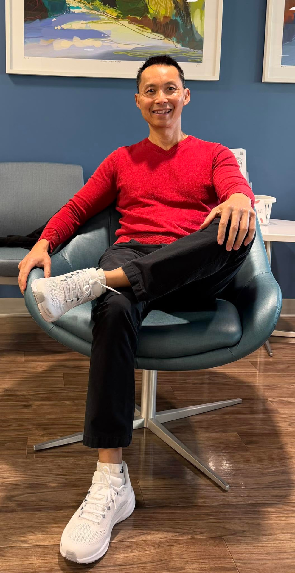 Sonny Nguyen seated, smiling